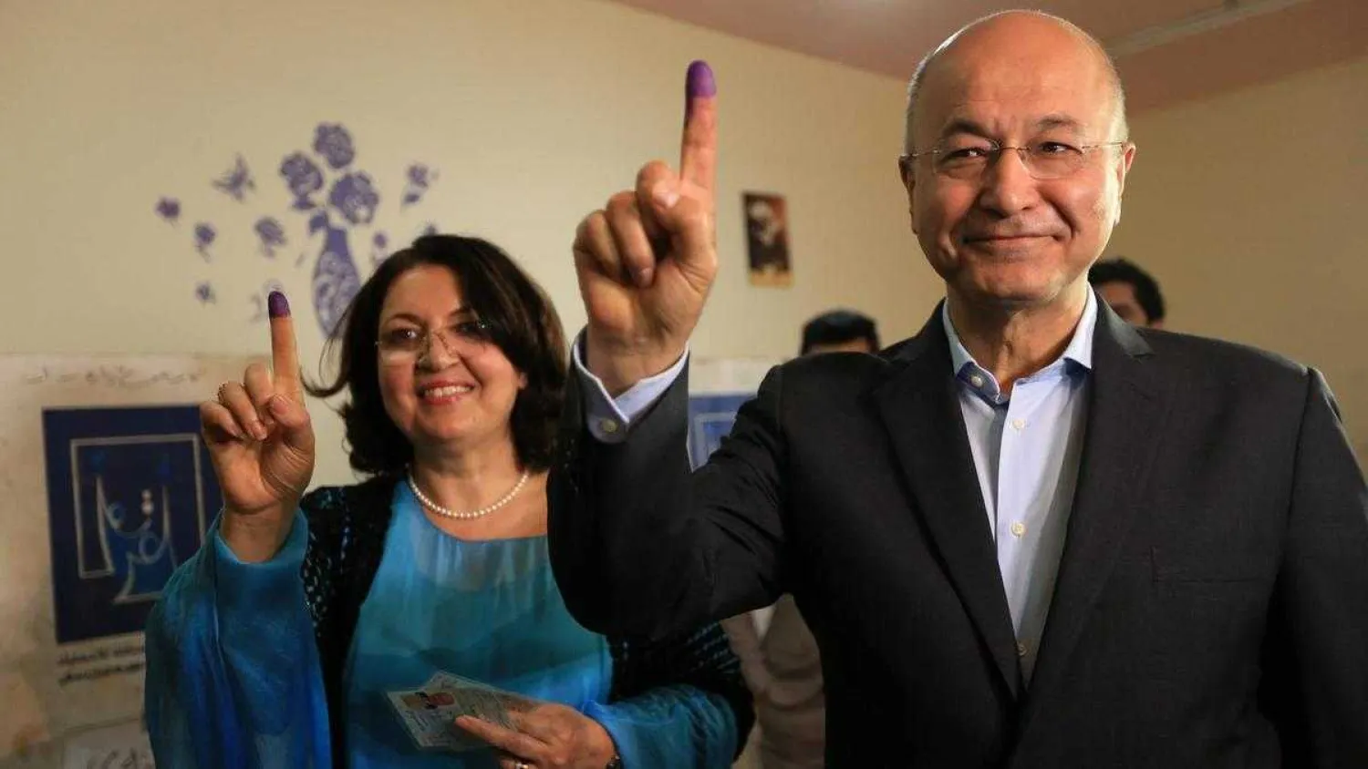 Barham Salih, Former Prime Minister of Iraq's Kurdistan Regional Government with his wife Sarbagh Salih show their ink-stained fingers after casting their votes at a polling station during the parliamentary election in Sulaymaniah. May 2018. Reuters