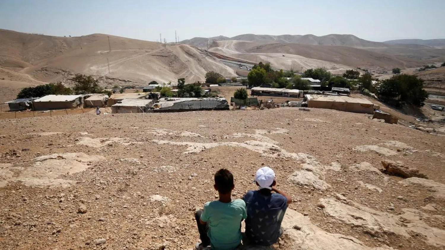  Palestinian boys sit in the Bedouin village of Khan Al-Ahmar near Jericho in the occupied West Bank. Mohamad Torokman / Reuters

 