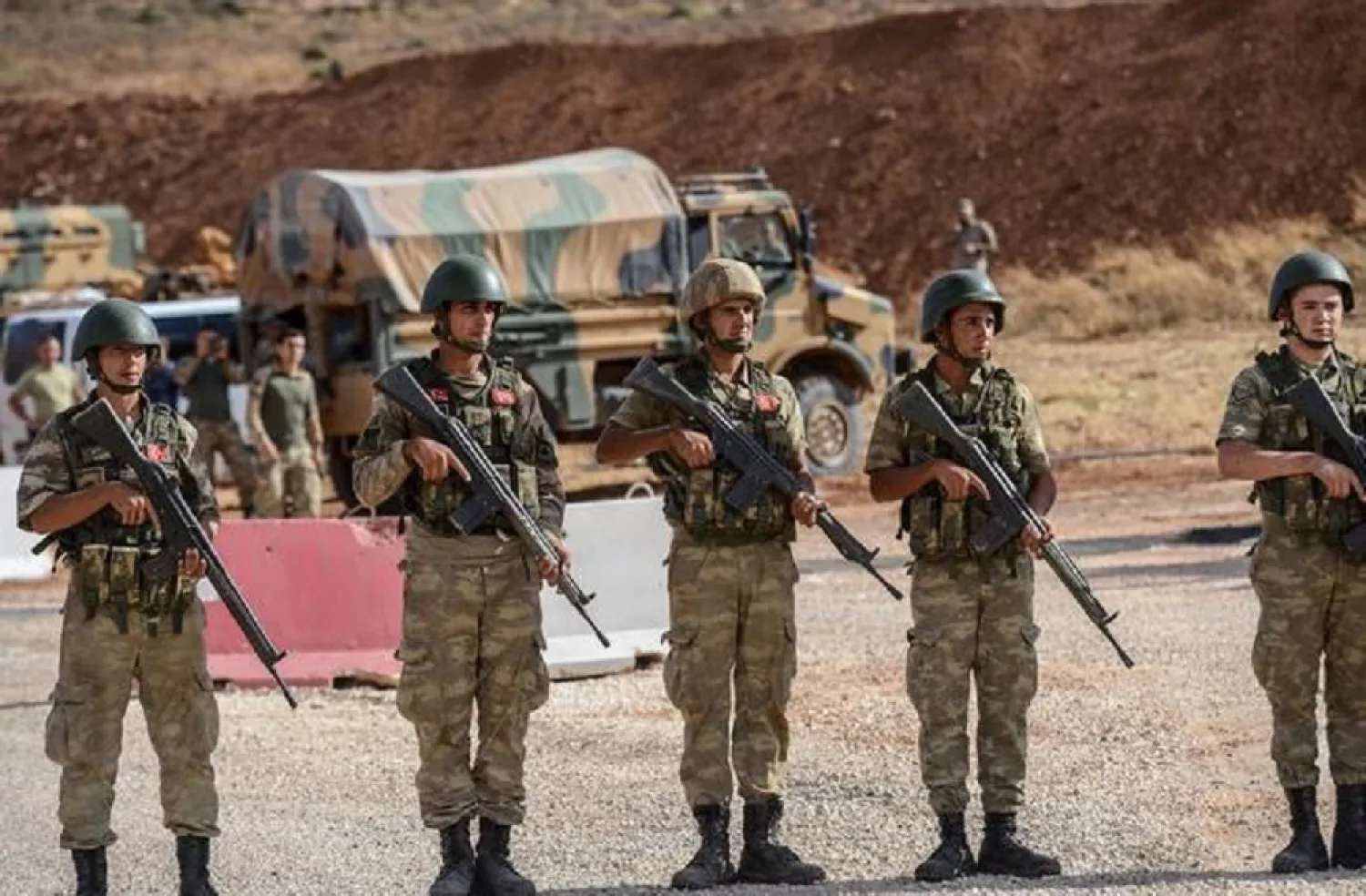 Turkish soldiers stand near armored vehicles near the Turkey-Syria border. (AFP)