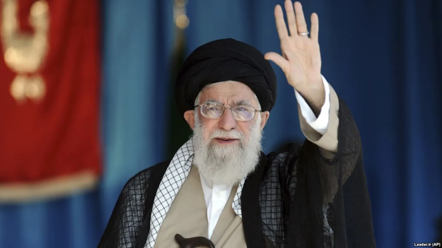 Iranian Supreme Leader Ali Khamenei waves to thousands of members of the Basij at Azadi stadium in Tehran on October 4. AP
