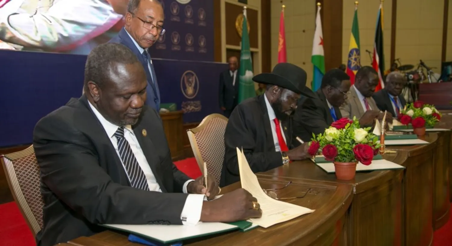 South Sudanese rebel leader Riek Machar, left, and South Sudan's President Salva Kiir sign a ceasefire deal in Khartoum, Sudan, in August. (Reuters)