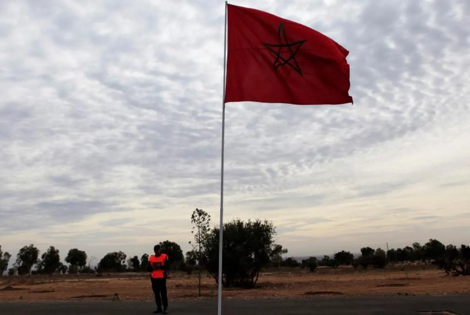 File photo of a police officer standing near a Moroccan national flag near the main stadium during preparations for the FIFA Club World Cup in Agadir, December 10, 2013. REUTERS/Amr Abdallah Dalsh
