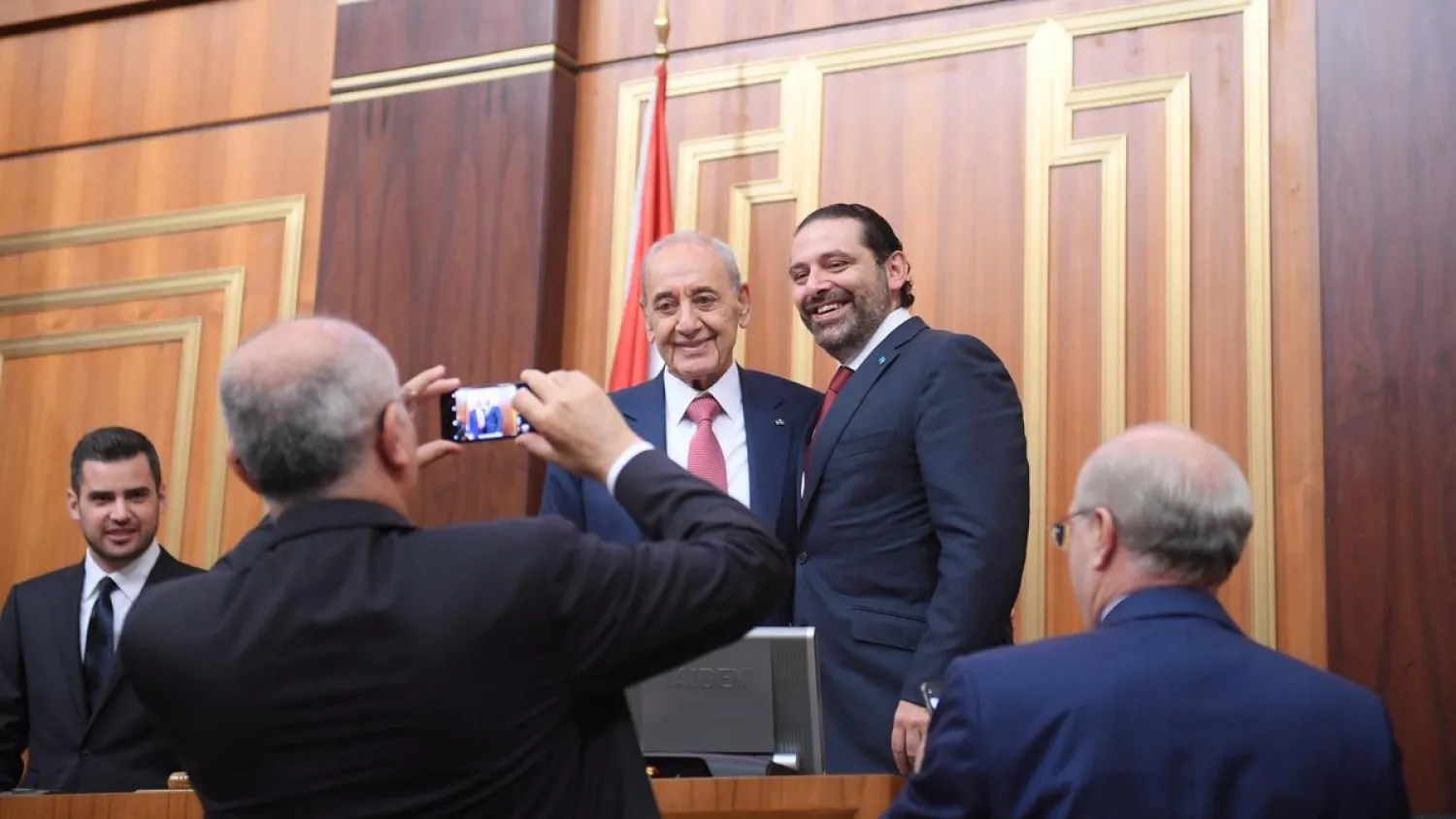 Lebanon's Finance Minister Ali Hassan Khalil takes photos of Speaker Nabih Berri and Prime Minister Saad Hariri at the parliament in Beirut. Reuters file photo