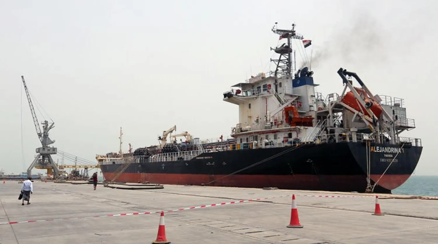 A man walks past a ship at the Red Sea port of Hodeidah, Yemen. (Reuters)
