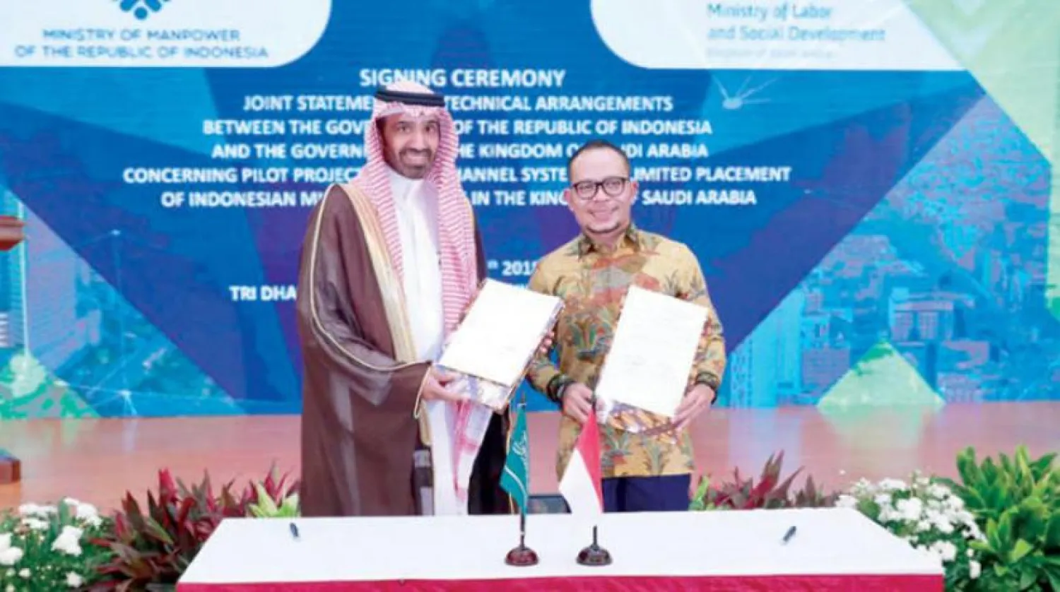 Minister of Labor and Social Development Ahmad al-Rajhi during the signing of the agreement in Jakarta. Asharq Al-Awsat