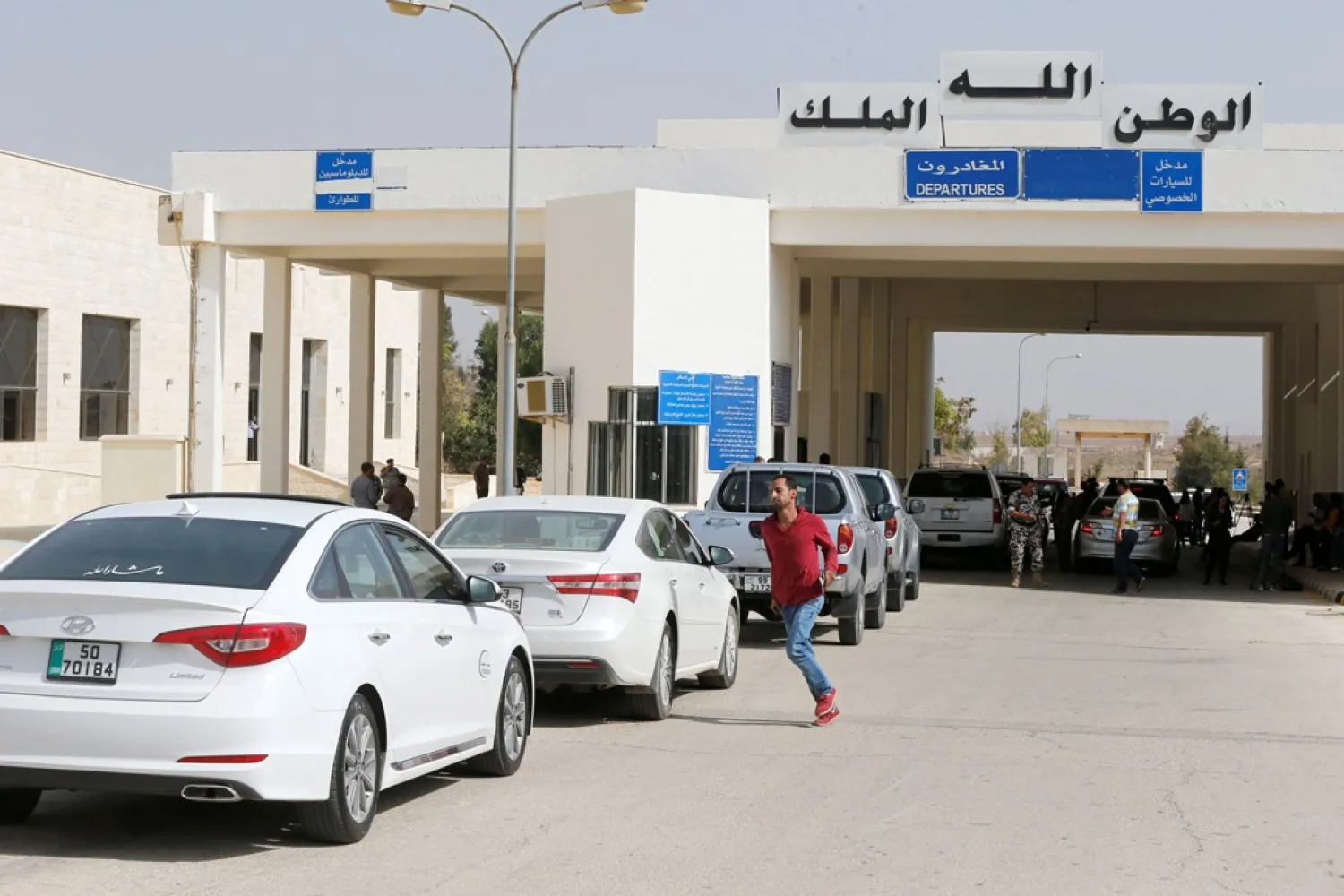 People wait to cross into Syria at Jordan's Jaber border crossing checkpoint. (Reuters)