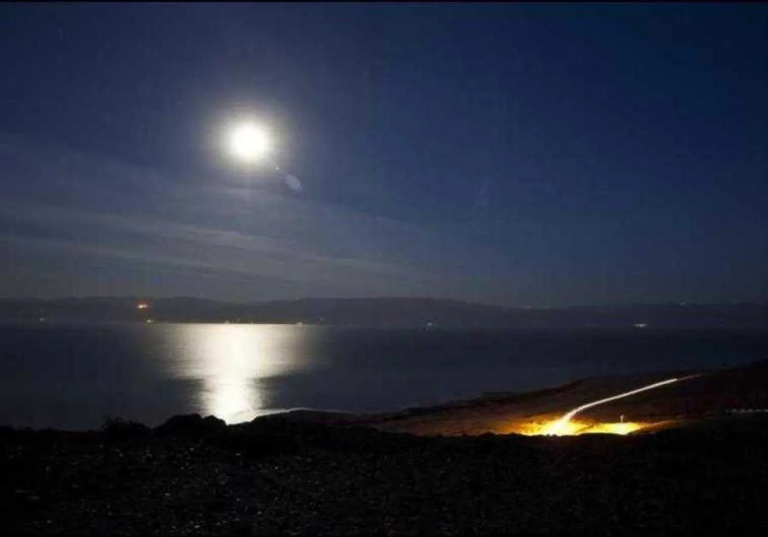 The moon shines in the night sky above the Dead Sea. (photo credit: REUTERS)