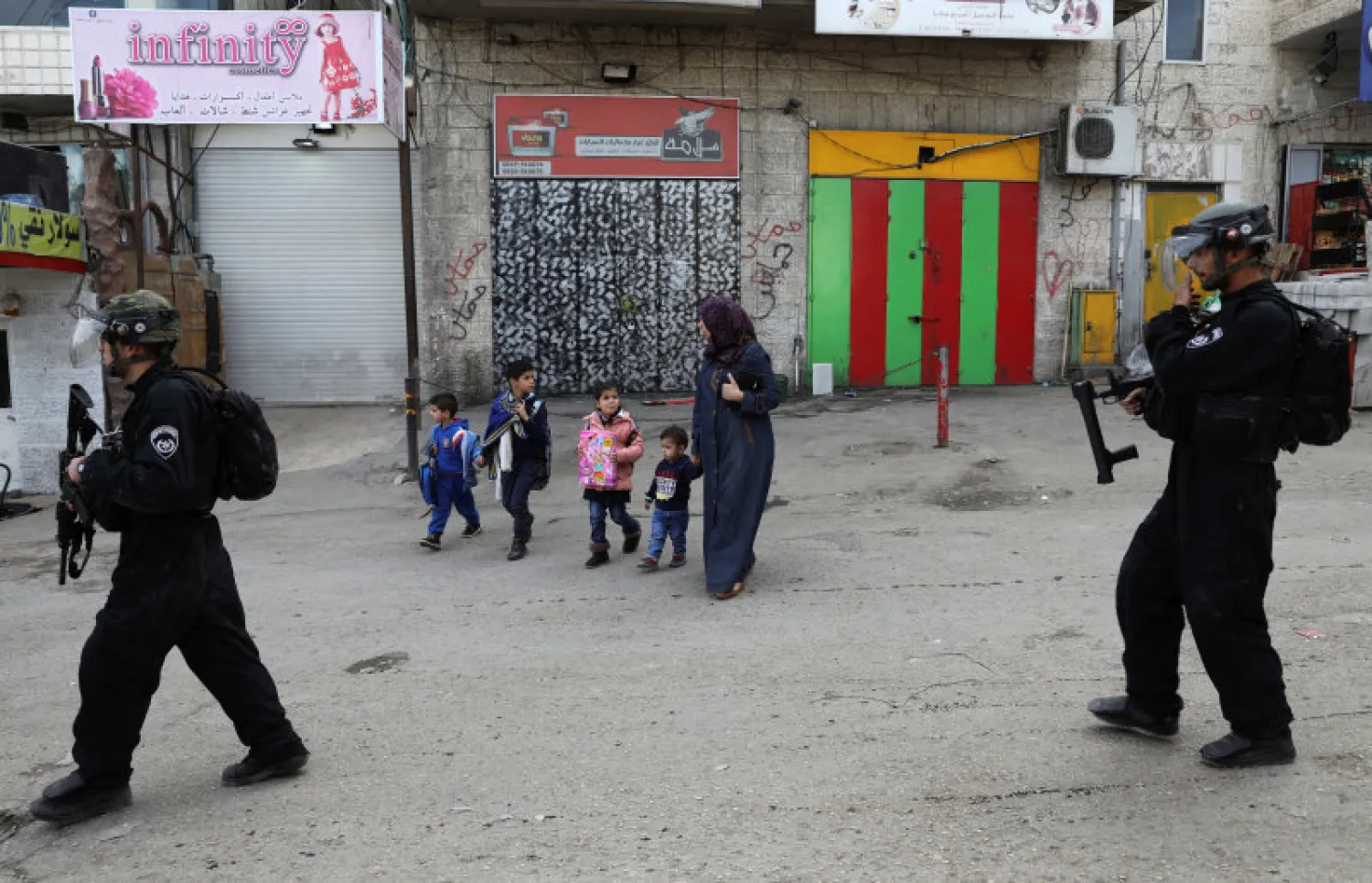 Israeli policemen patrol a street in the East Jerusalem refugee camp of Shuafat (Reuters)