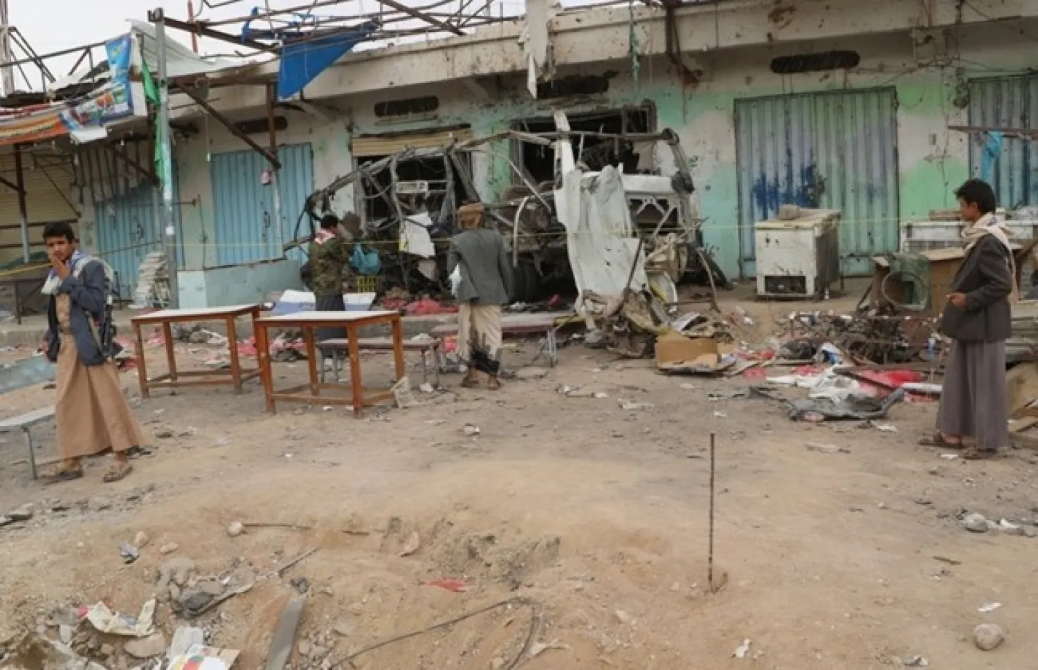 People inspect ta battle scene in Saada province, Yemen August 10, 2018. REUTERS/Naif Rahma