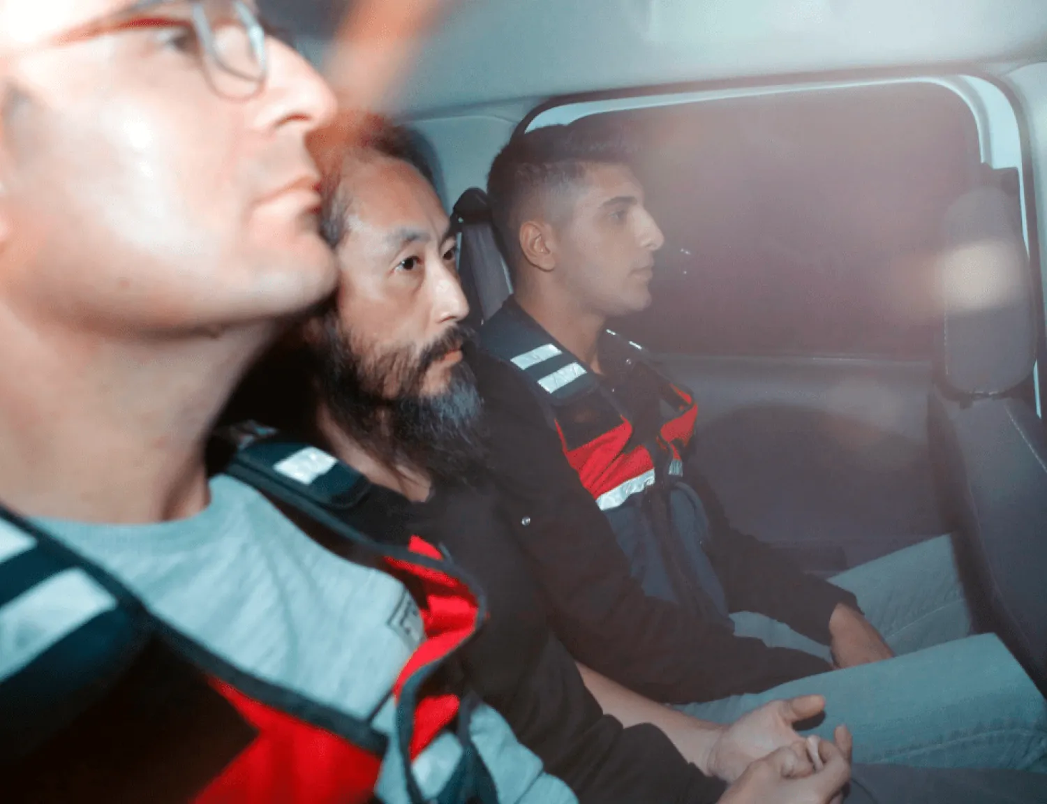 Japanese journalist Jumpei Yasuda, center, is driven out of the immigration center in Antakya, Turkey, Wednesday, Oct. 24, 2018. Yasuda was freed after more than three years of captivity in Syria Wednesday. (Yosuke Mizuno/Kyodo News via AP)