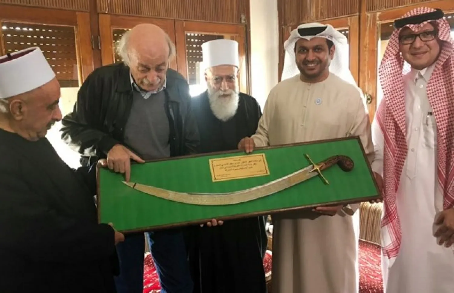 Sheikh Ali Zeineddine gifts Saudi Ambassador to Lebanon Walid al-Bukhari and UAE ambassador Hamad bin Saeed al-Shamsi antique swords in the Chouf, Friday, Oct. 26, 2018.