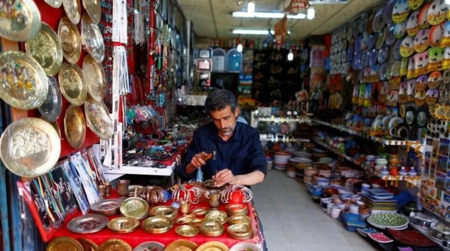 Kamel, 56, a brass carver and vendor of souvenirs, works at his shop as he waits for customers in the old city of Sousse, Tunisia June 23, 2016. REUTERS/ Zohra Bensemra
