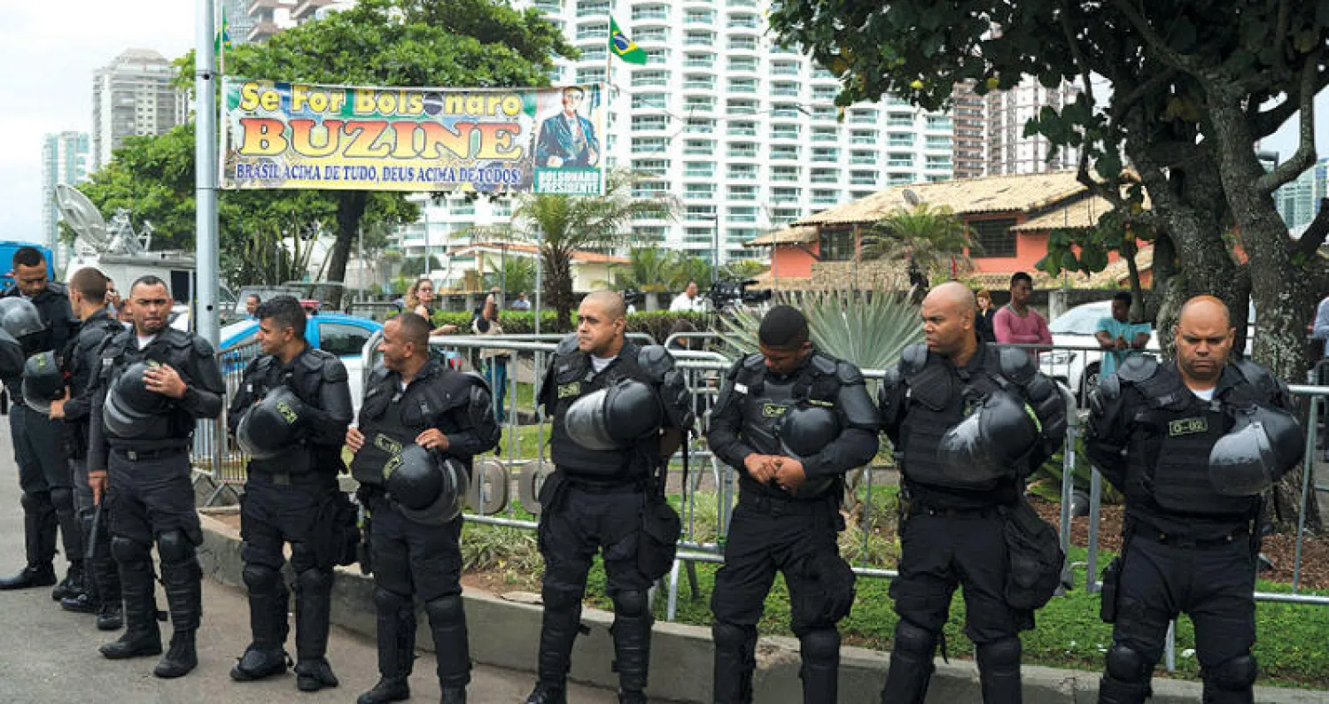 عناصر شرطة يحرسون بيت الرئيس البرازيلي اليميني المنتخب جايير بولسونارو (أ.ب)