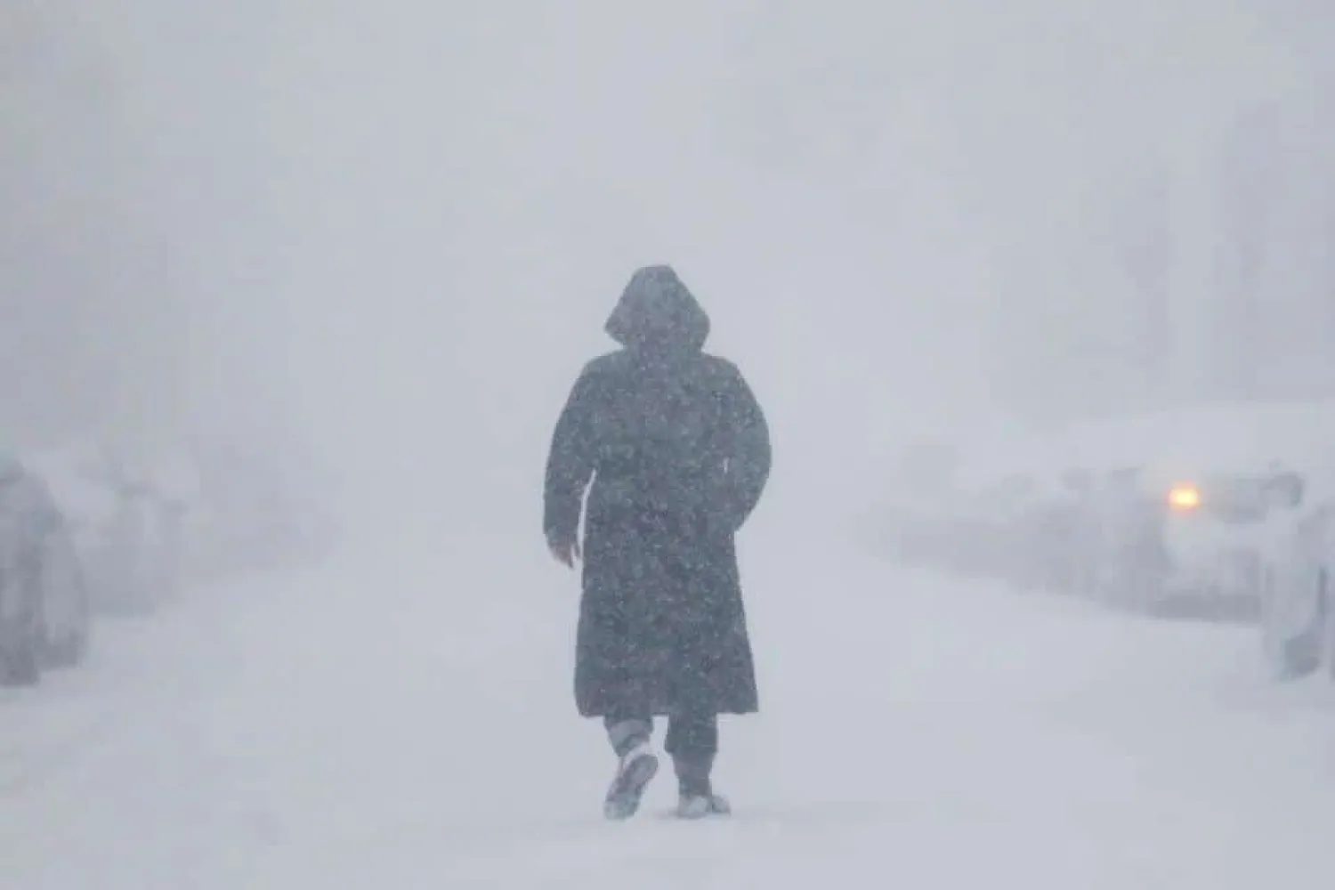 A woman walks down the street during a blizzard in Long Beach, New York. (Reuters)