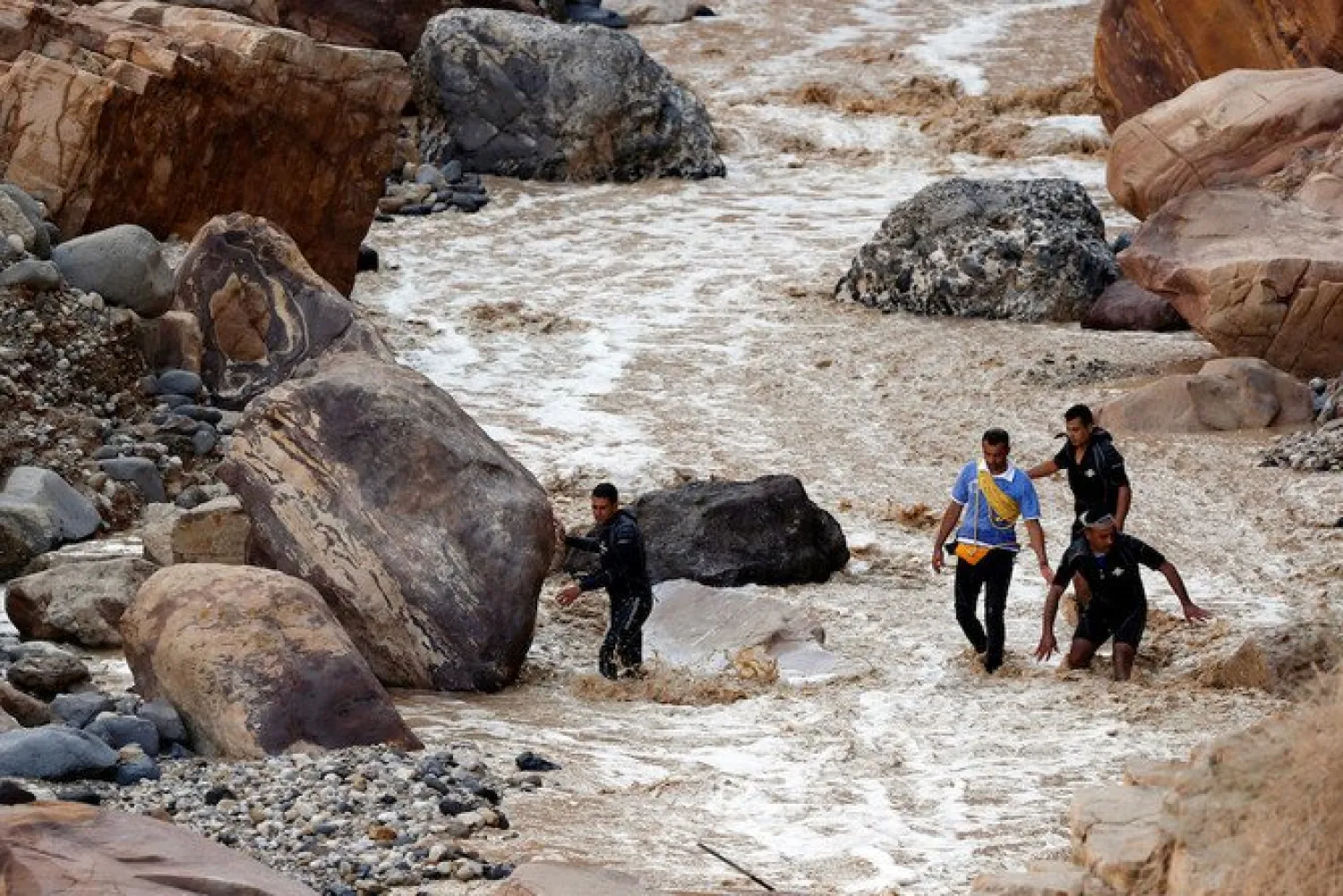 Civil defense members look for survivors after rainstorms unleashed flash floods, near the Dead Sea. (Reuters)