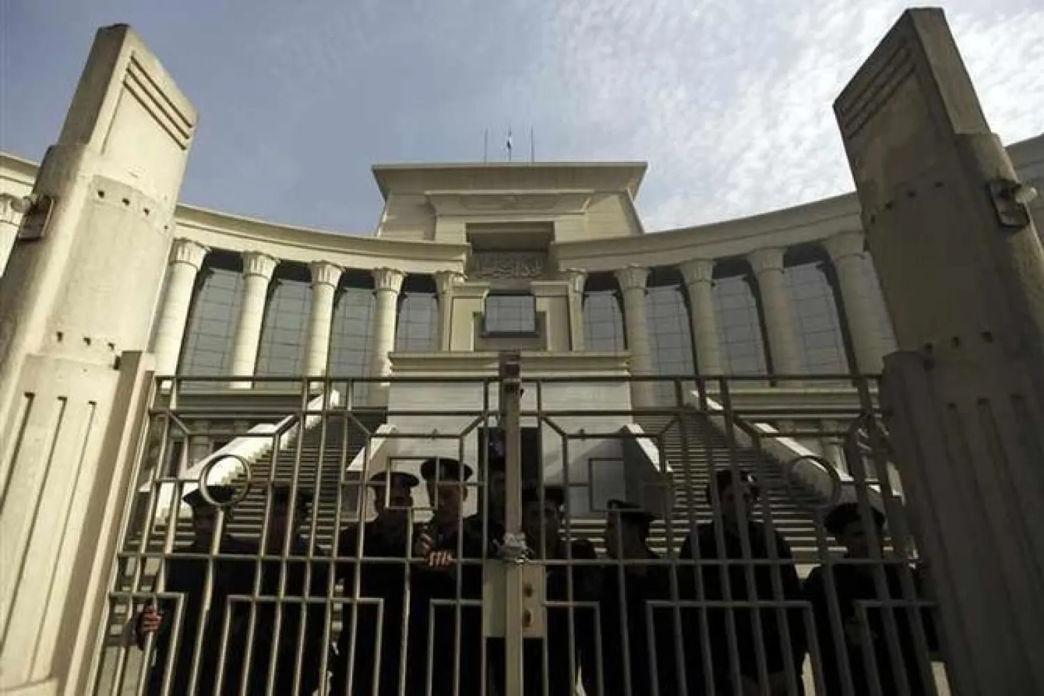 Police stand guard behind a gate in front of the Supreme Constitutional Court. (File photo by Reuters)