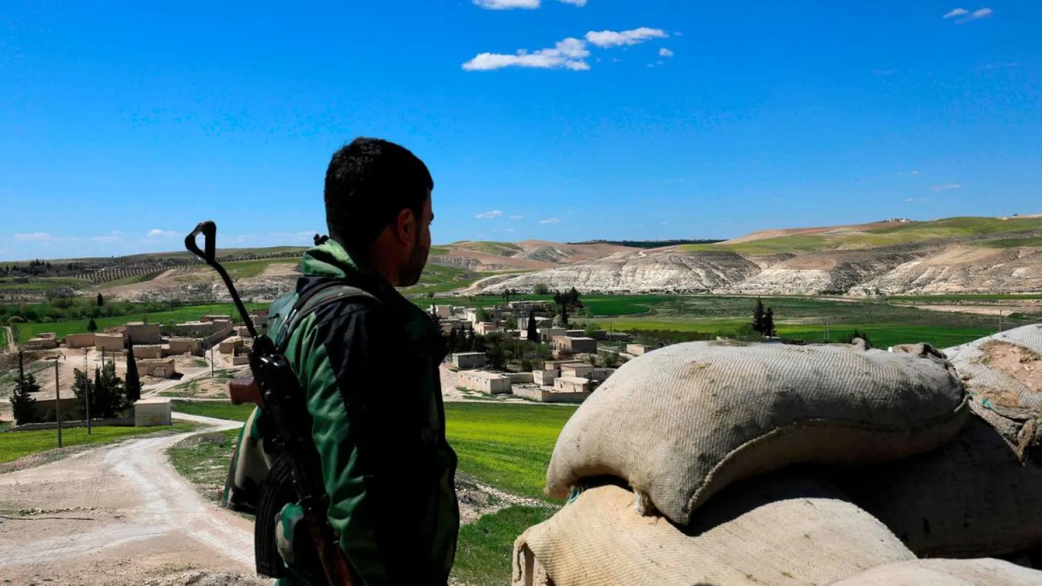 A fighter from the Manbij Military Council stands guard near the village of Awshariyah, north of Manbij. (AFP)