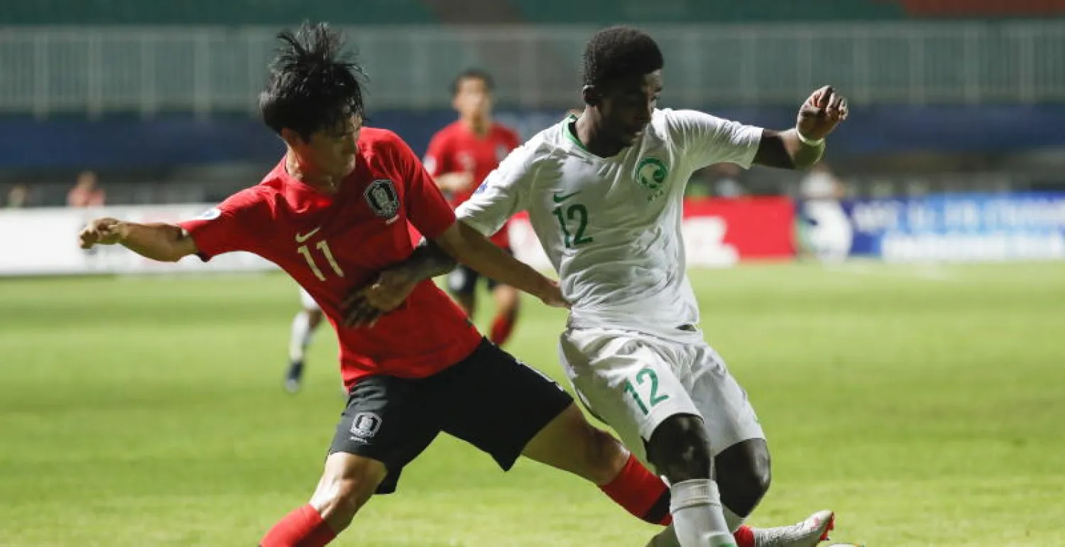 اللاعب السعودي محمد الشنقيطي (يمين) واللاعب الكوري الجنوبي سانغ يوم ون في المباراة (إ.ب.أ)