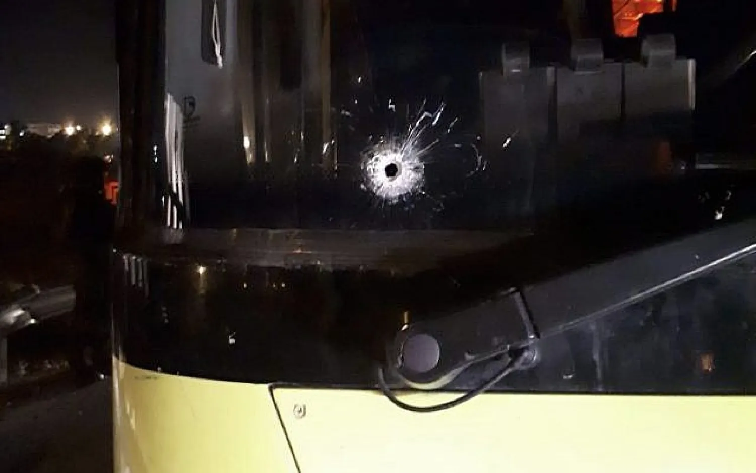 A bullet-hole is seen in the window of a bus that was fired upon on Route 466 in the West Bank near the settlement of Beit El on November 7, 2018. (Beit El security)

