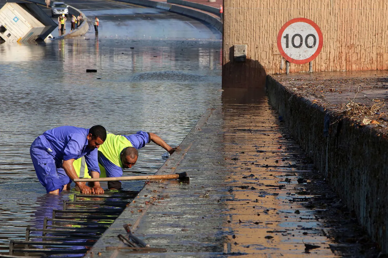 Municipality workers try to drain a flooded underpass in Kuwait City, November 6, 2018. (AFP)