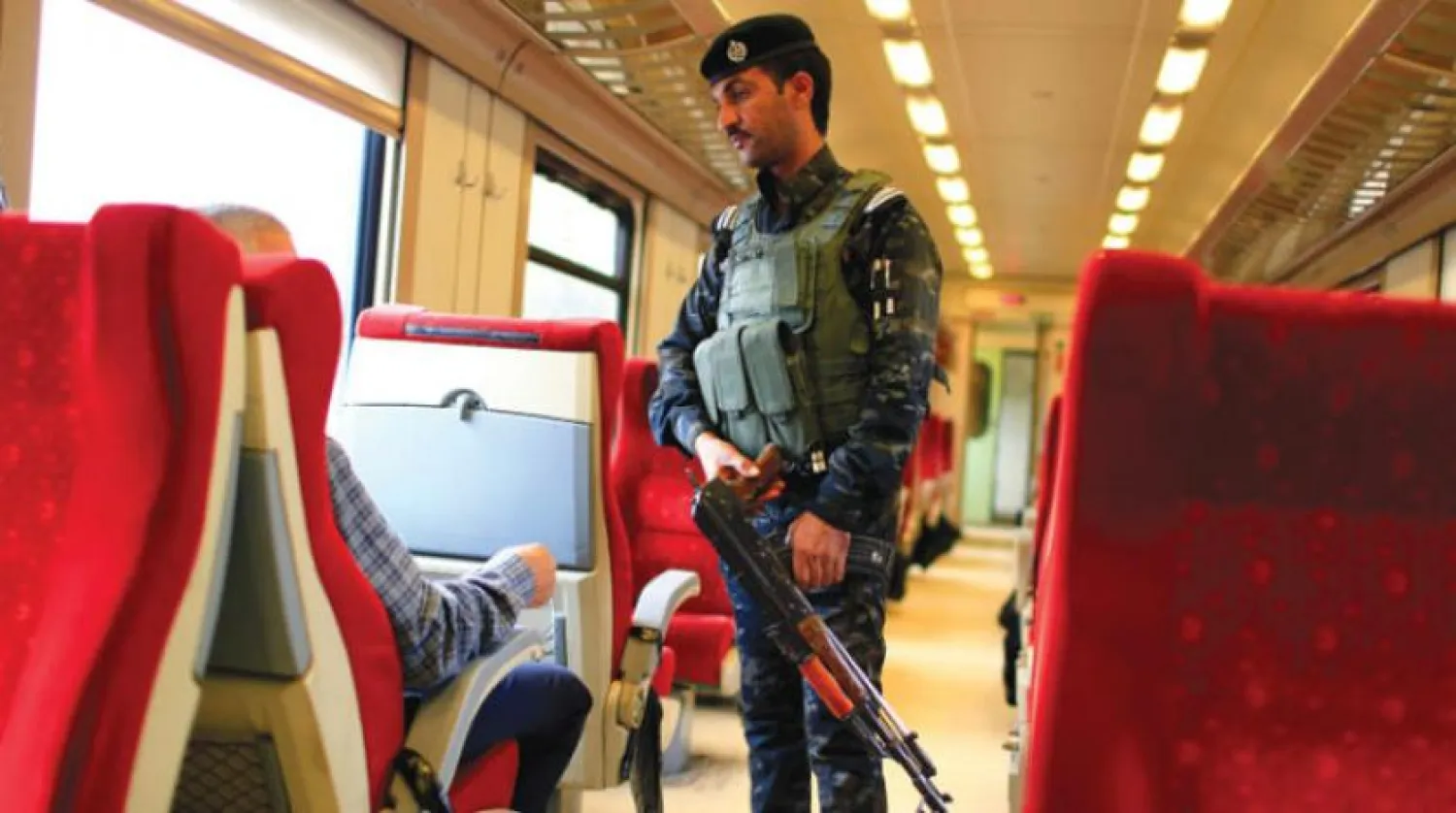 An Iraqi Policeman stands guard in a passenger cabin of the train on the way to Fallujah after leaving Baghdad Railway Station, the newly resurrected service to the city, in Baghdad, Iraq November 7, 2018. Picture taken November 7, 2018. REUTERS/Thaier al-Sudani