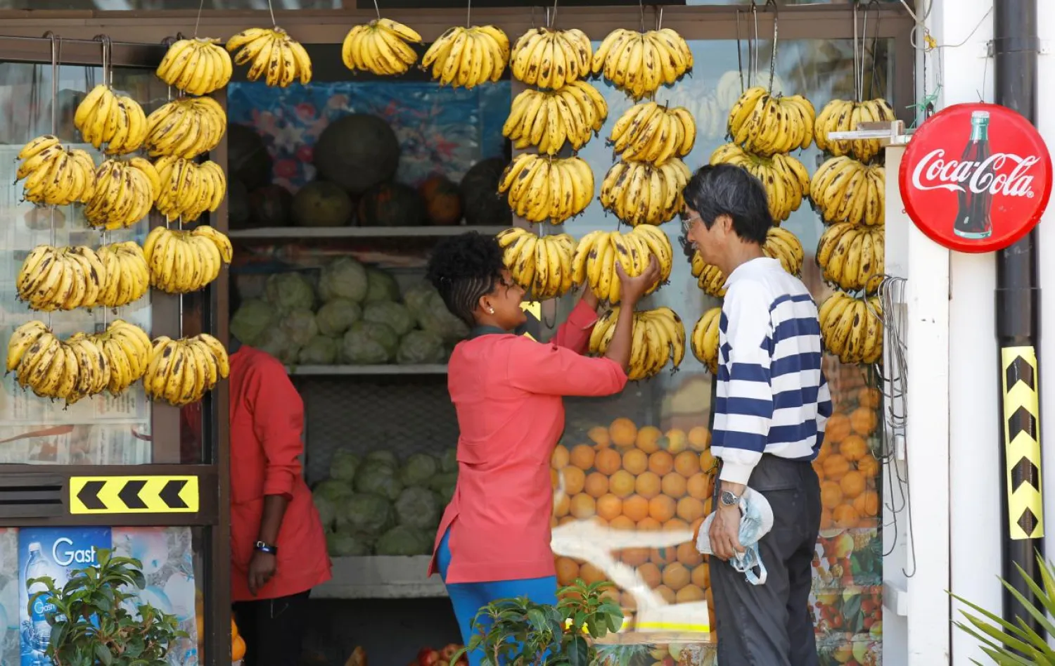 A vendor sells bananas to a customer at her grocery shop in downtown Asmara, Eritrea in this photo taken on February 21, 2016. (Reuters)