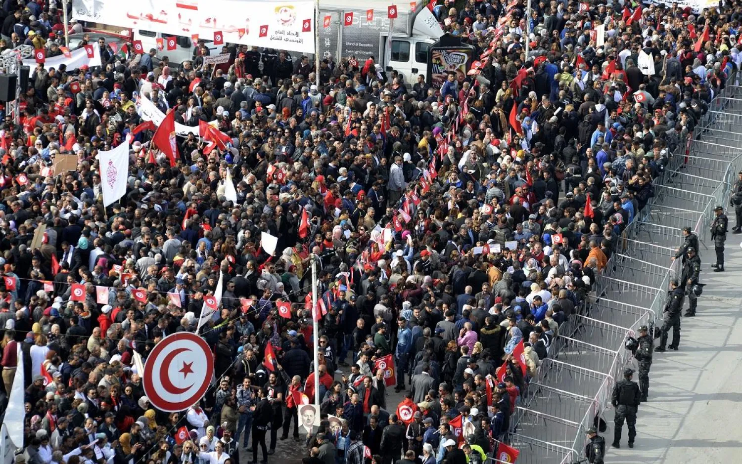 Tunisian protesters wave national flags and chant slogans during a civil servants' general strike in the capital Tunis on November 22, 2018. (AFP)