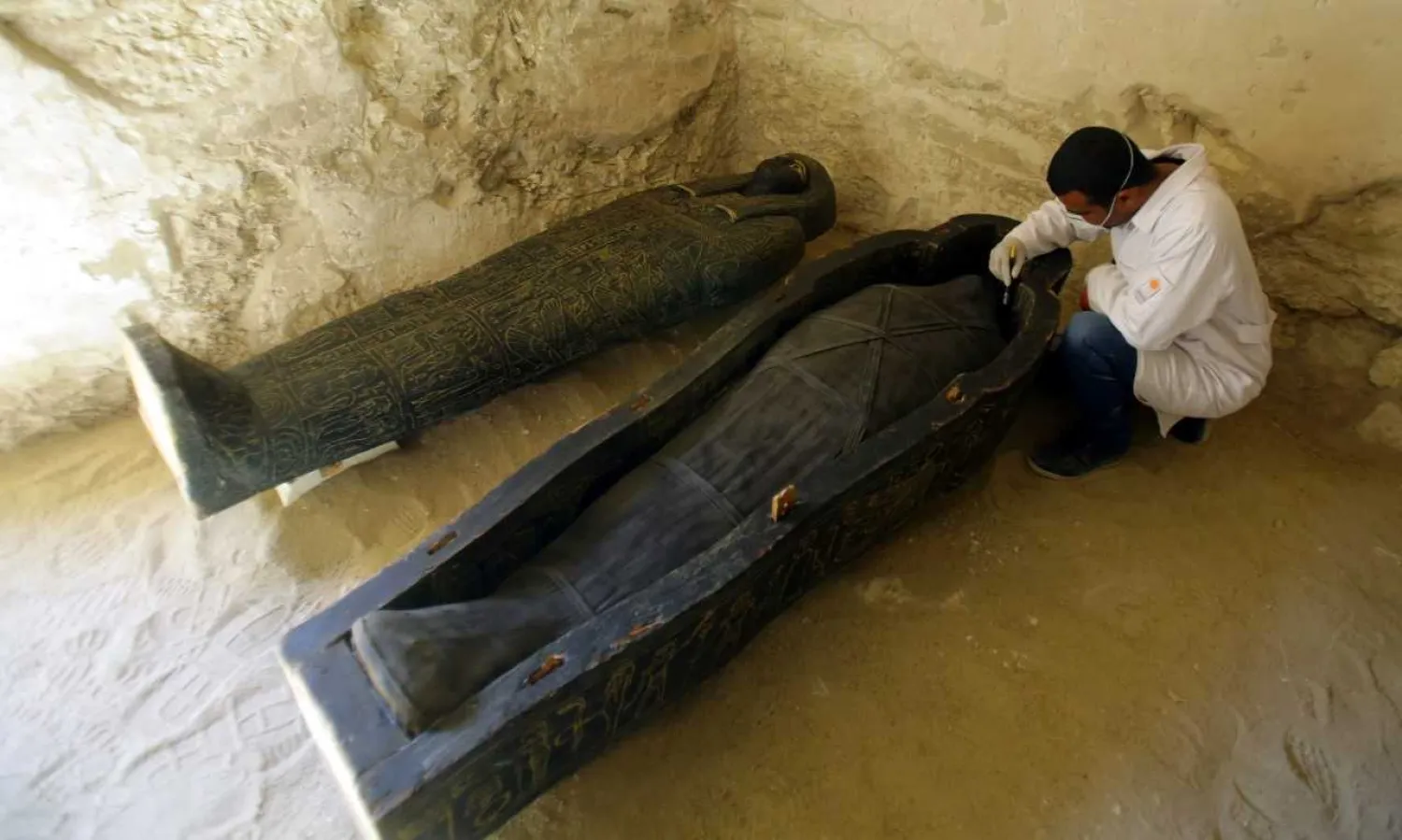 An Egyptian archaeologist works on restoring sarcophagi inside a tomb at al-Assassif Necropolis, in Luxor, 700km south of Cairo, Egypt, 24 Novmber 2018. EPA