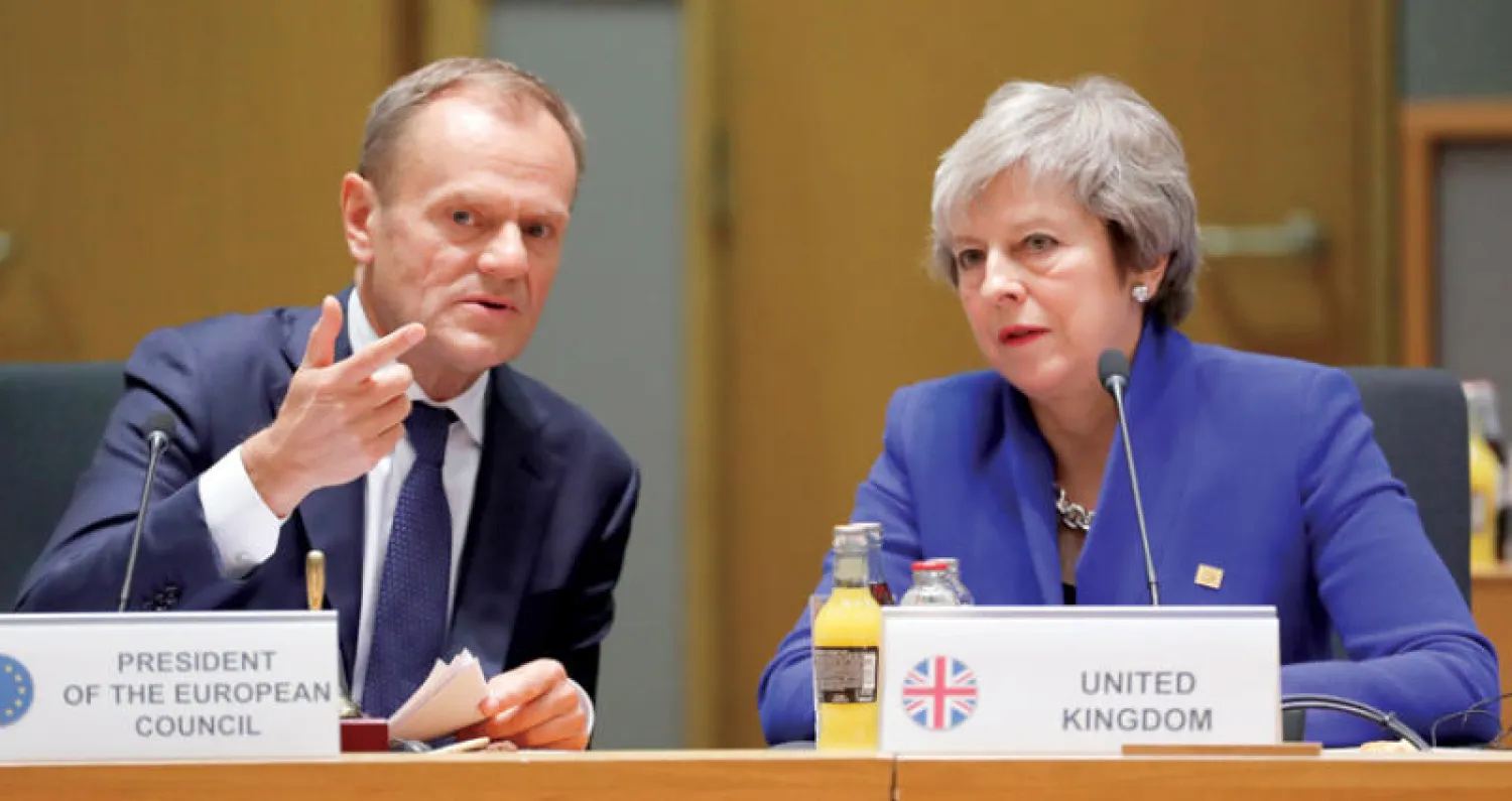ماي وتوسك خلال القمة الأوروبية الاستثنائية في بروكسل أمس (أ.ب)