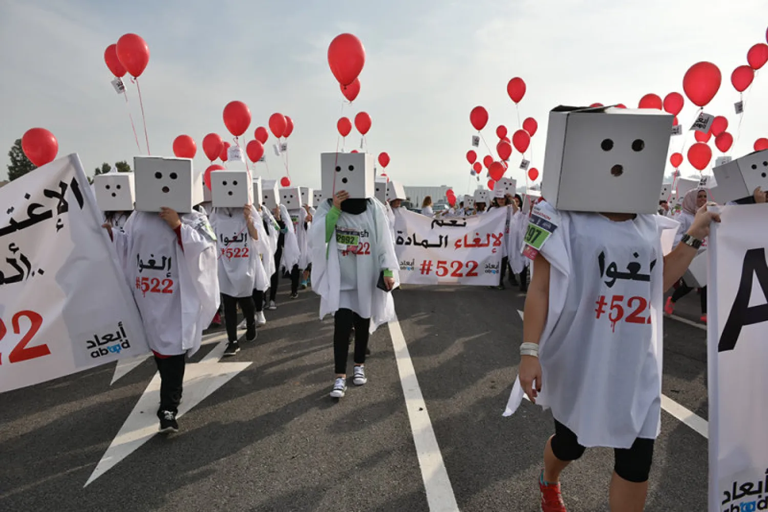 Activists marching in the streets during the Beirut marathon in protest of article 522. Photo credit: ABAAD