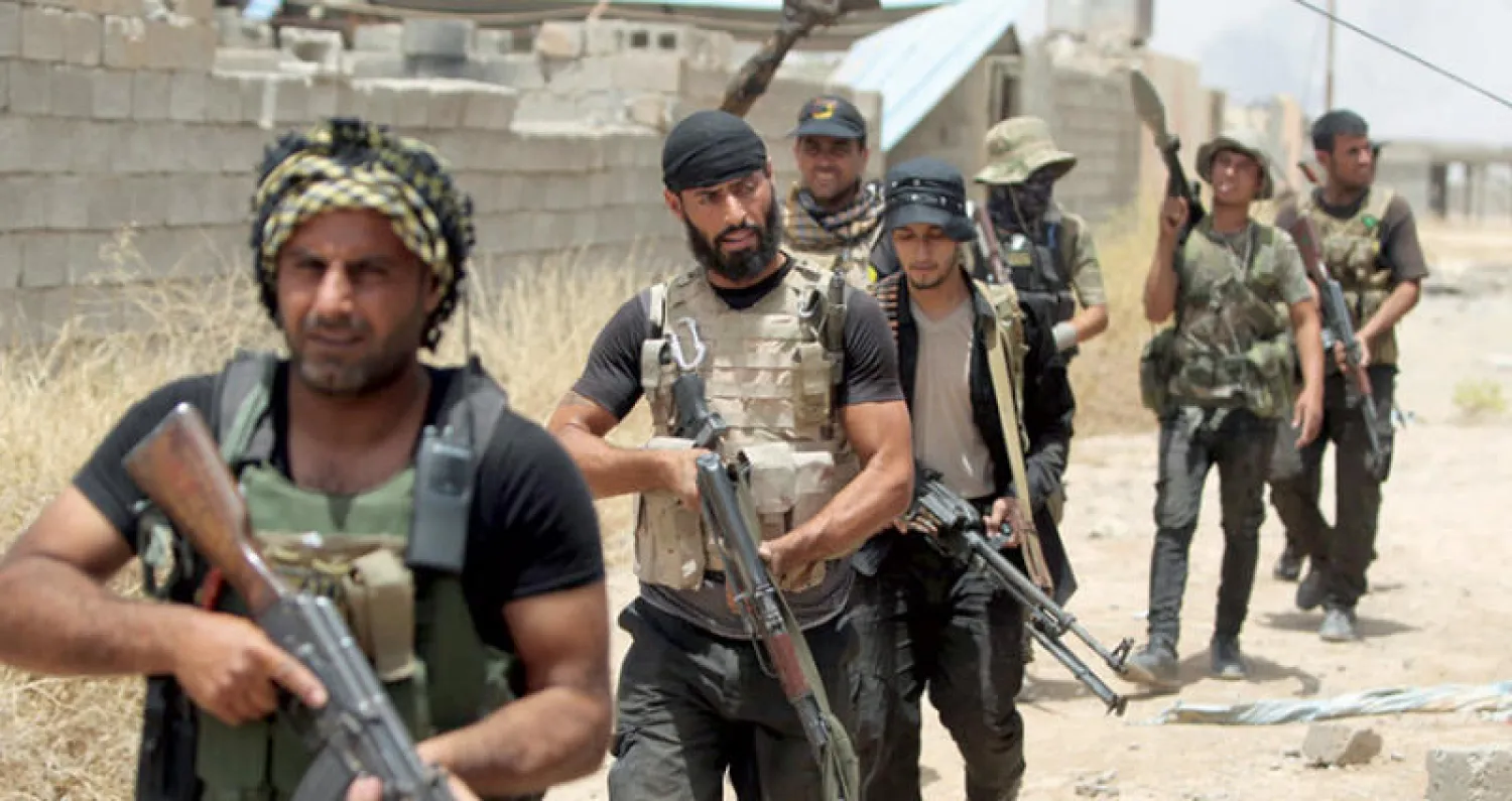 مسلحو أحد فصائل الحشد في إحدى مناطق محافظة صلاح الدين (أ.ف.ب)