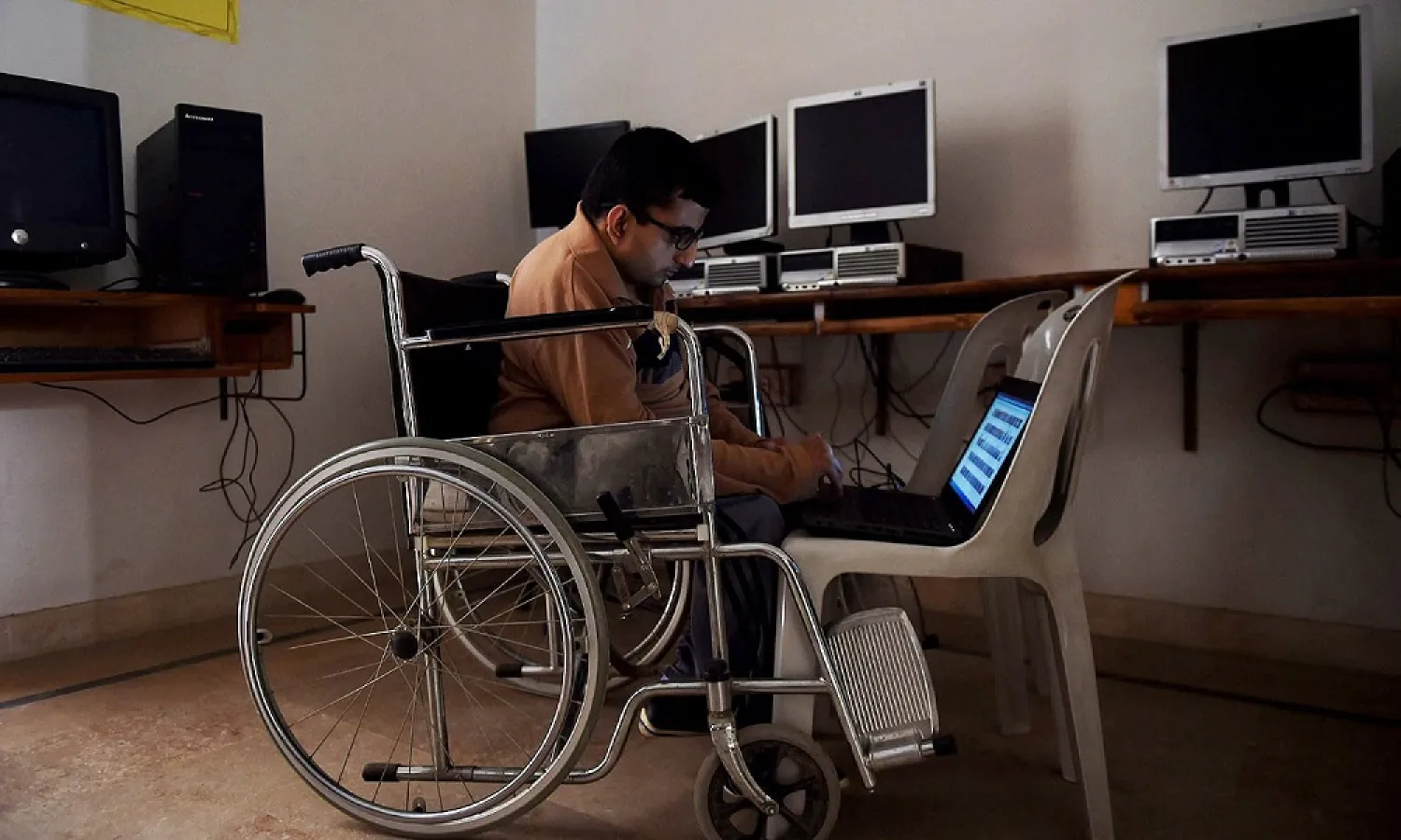 A disabled Pakistani student uses a laptop at a computer training center in Karachi. (AFP)
