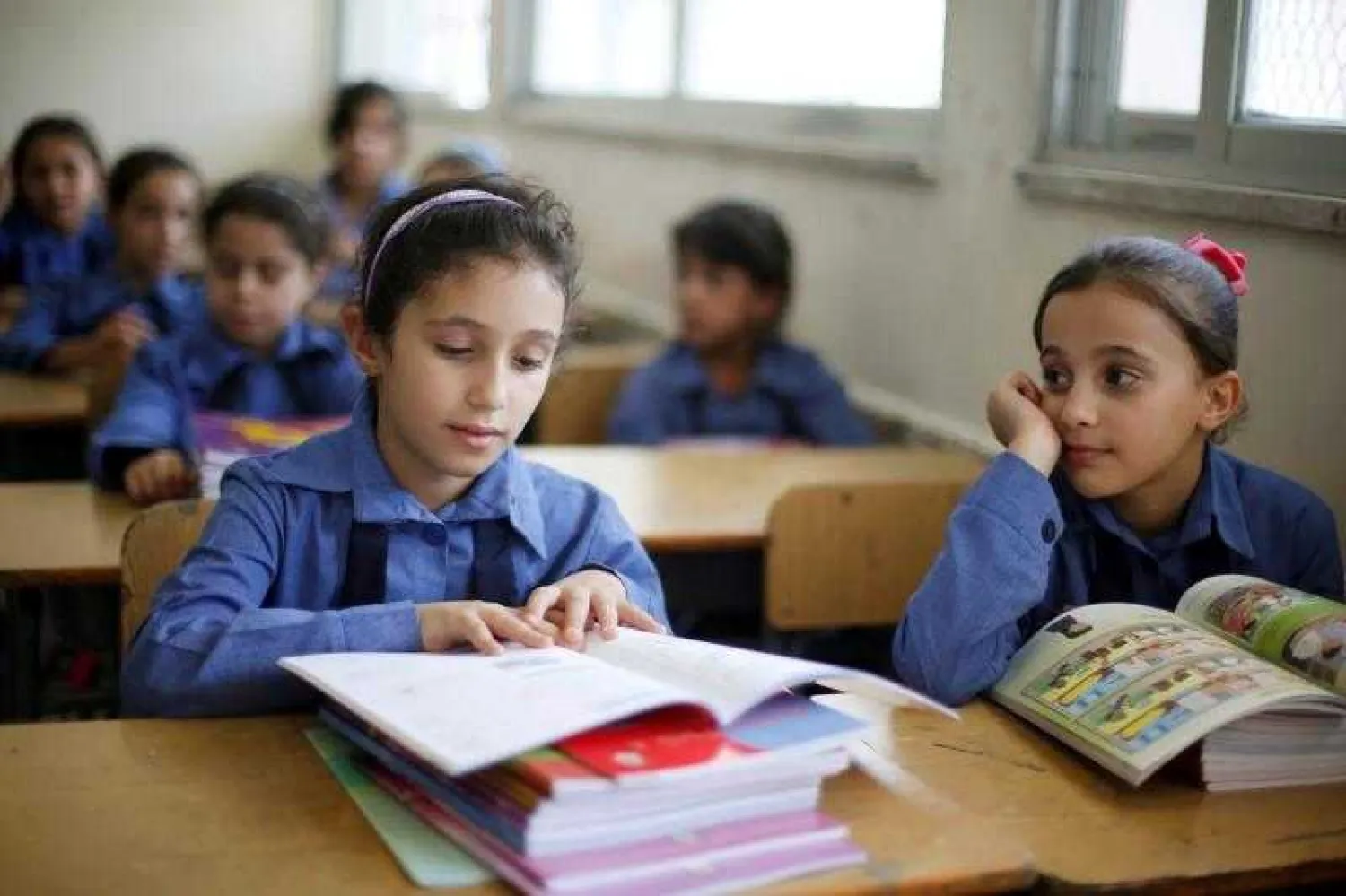 Refugee schoolchildren receive their new books on the first day of the new school year at one of the UNRWA schools at a Palestinian refugee camp al Wehdat, in Amman, Jordan, September 1, 2016. REUTERS/Muhammad Hamed