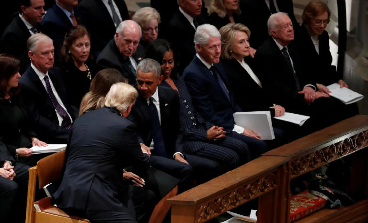 ترمب وميلانيا إلى جوار الرؤساء السابقين أوباما وكلينتون وكارتر وزوجاتهم في جنازة بوش الأب (رويترز)