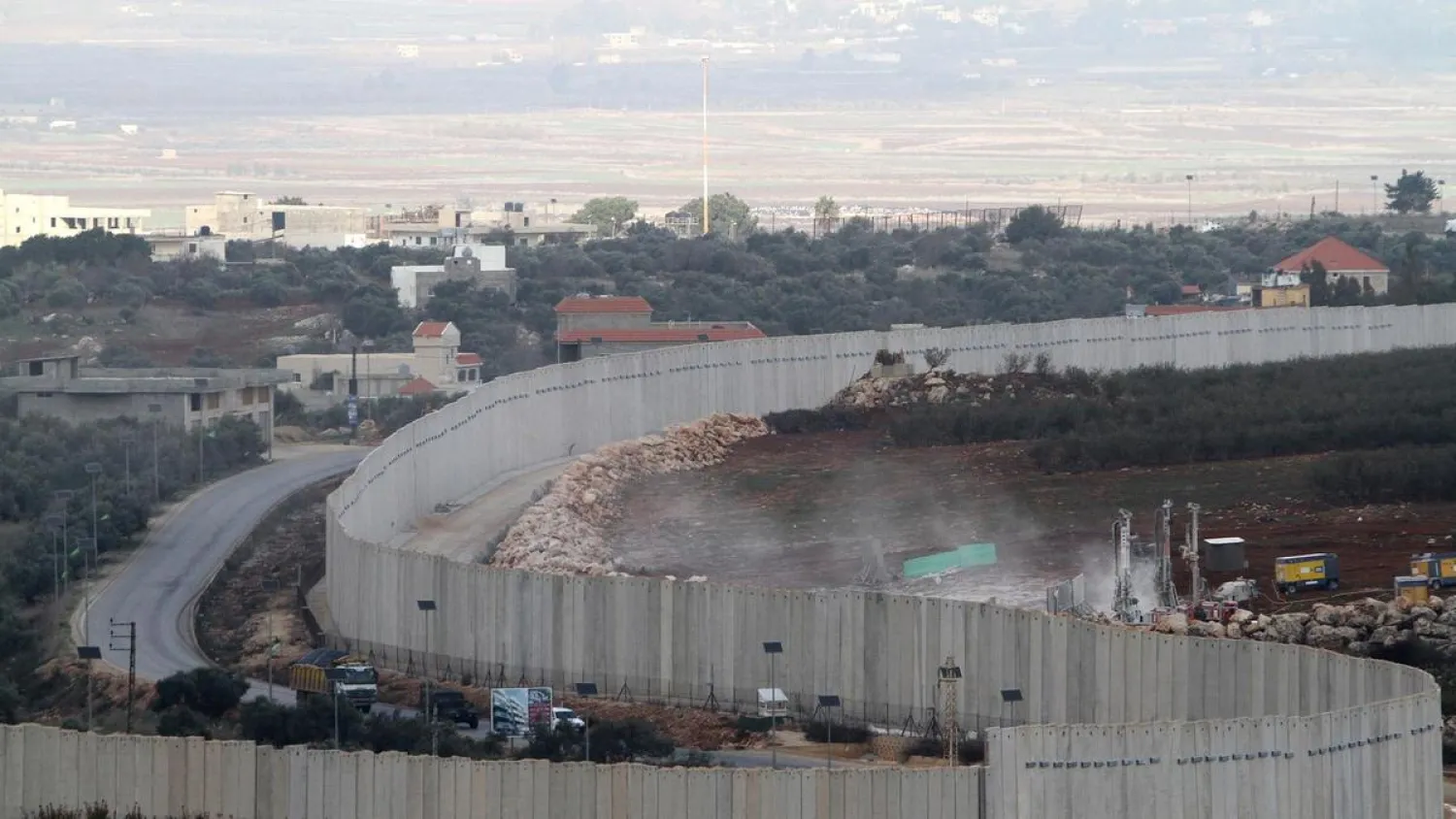 Israeli military diggers work on the Lebanese-Israeli border next to a wall that was built by Israel in the southern village of Kfar Kila, Lebanon, Tuesday, December 4, 2018. (AP)