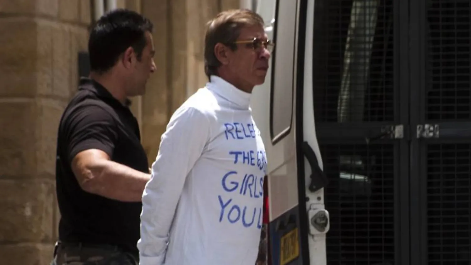 Egyptian Seif al-Din Mohamed Mostafa is escorted to an extradition hearing in the Cypriot capital Nicosia on May 13, 2016 | AFP