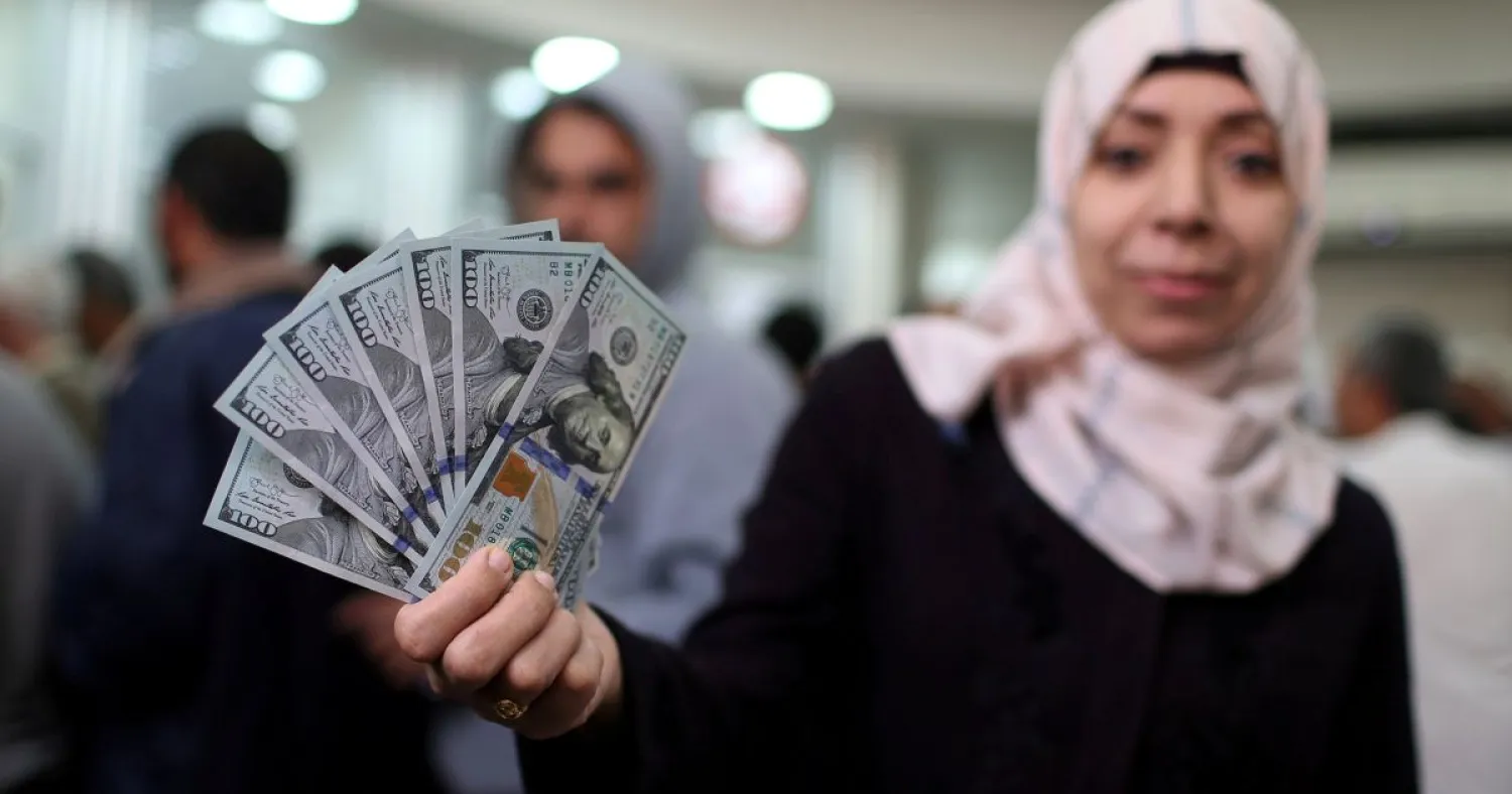 A Hamas official receiving her salary, November 9, 2018. Ibrahim Abu Mustafa/Reuters