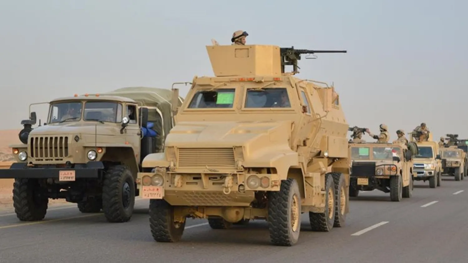 Egyptian military vehicles drive down a highway towards North Sinai. (Reuters)