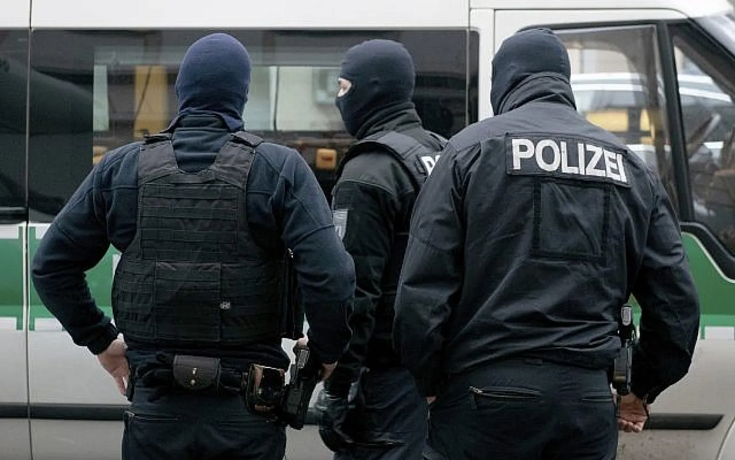 Police officer stand in front of a mosque in Berlin on Dec. 18, 2018, which is searched as part of an investigation into its imam on suspicion he raised money to support an extremist in Syria (Paul Zinken/dpa via AP)