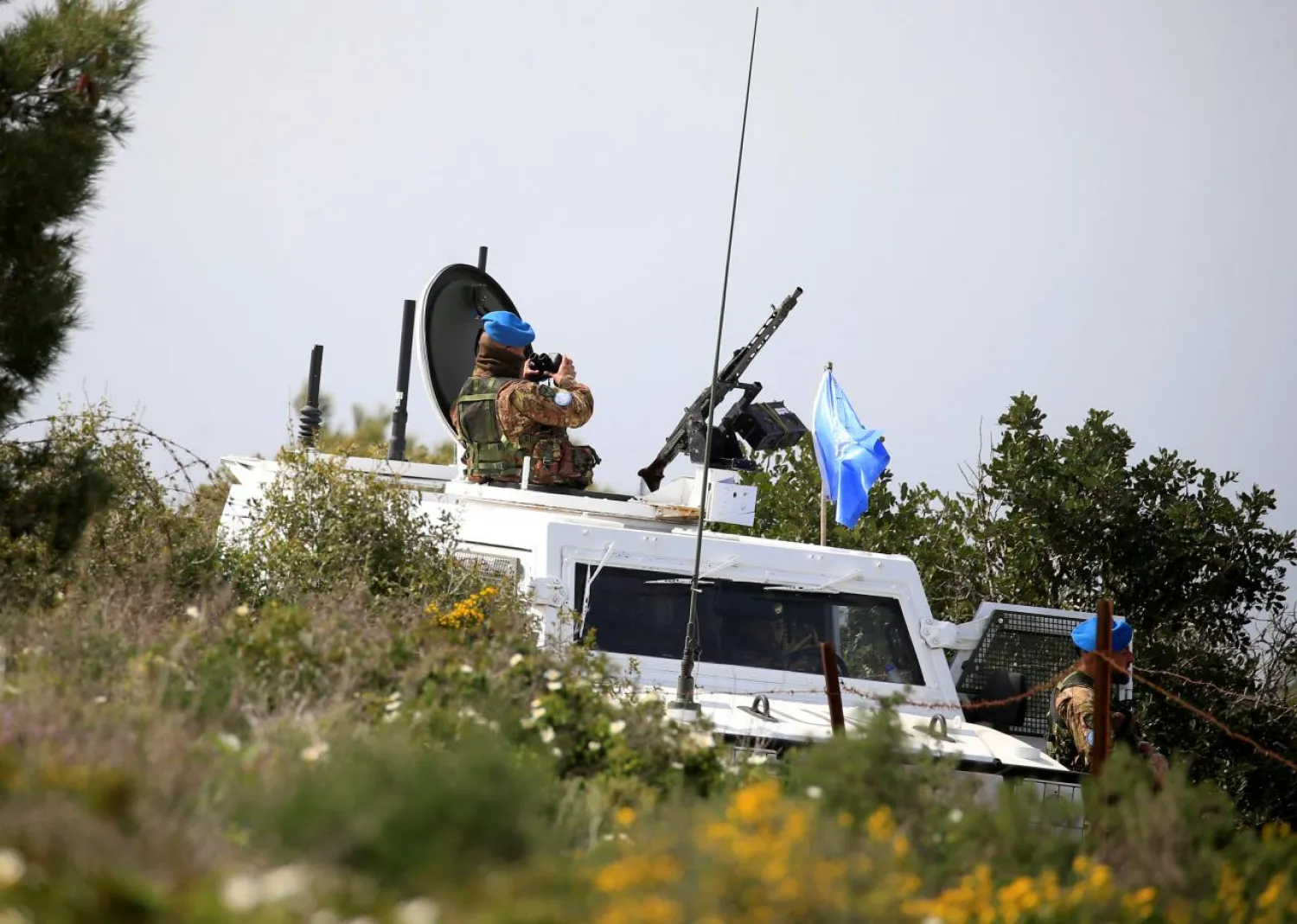 United Nations Interim Force in Lebanon (UNIFIL) peacekeepers watch as Israeli workers build a wall near the border with Israel, near the village of Naqoura, Lebanon March 6, 2018. REUTERS/Ali Hashisho

 