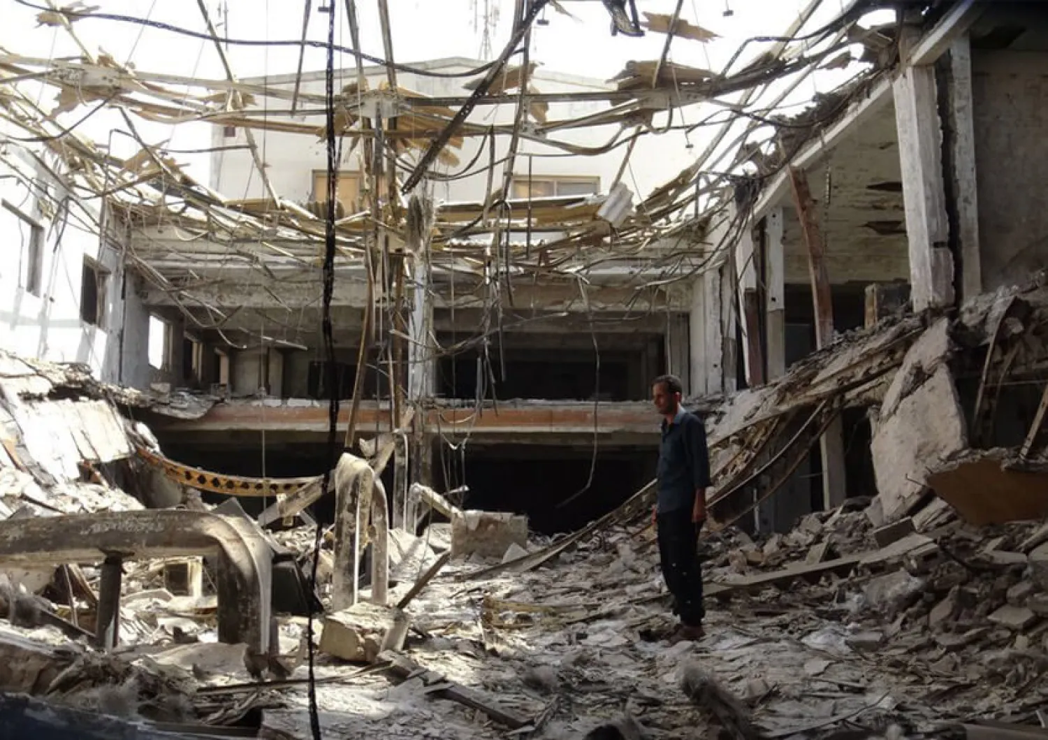 A man inspects the ruins of a factory hit by fierce fighting for the Yemeni port city of Hodeidah that a UN-brokered truce which went into effect on Tuesday is intended to halt | AFP