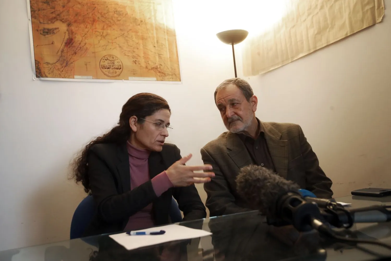 Co-chairs of the Kurdish-led Syrian Democratic Council Ilham Ahmad, left, and Riad Darrar attend a press conference in Paris, Friday, Dec. 21, 2018. Against the advice of many in his own administration, President Donald Trump is pulling US troops out of Syria.(AP Photo/Christophe Ena)