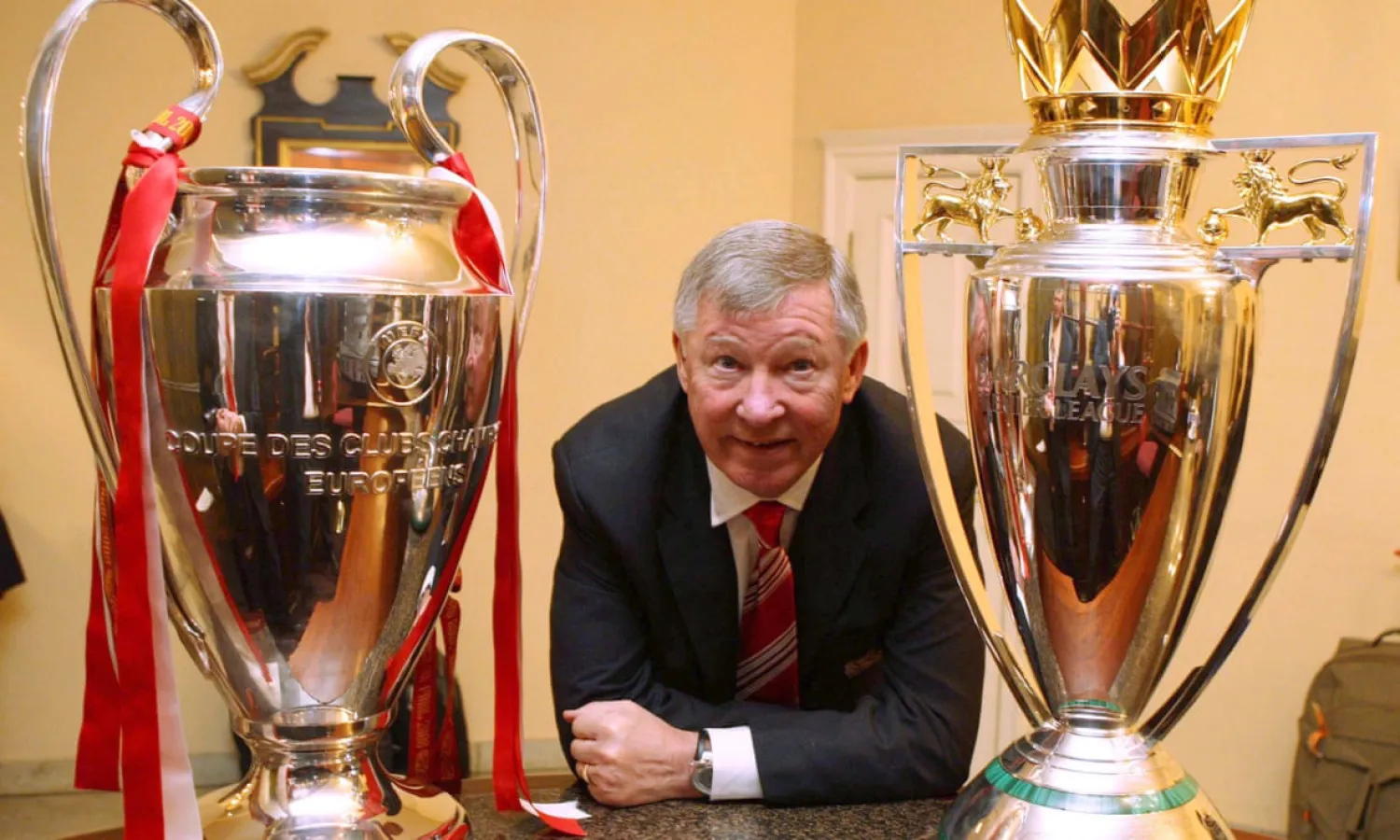 Sir Alex Ferguson is flanked by the Champions League trophy (left) and the Premier League trophy after Manchester United’s outstanding 2007-2008 season. Photograph: John Peters/Man Utd via Getty Images