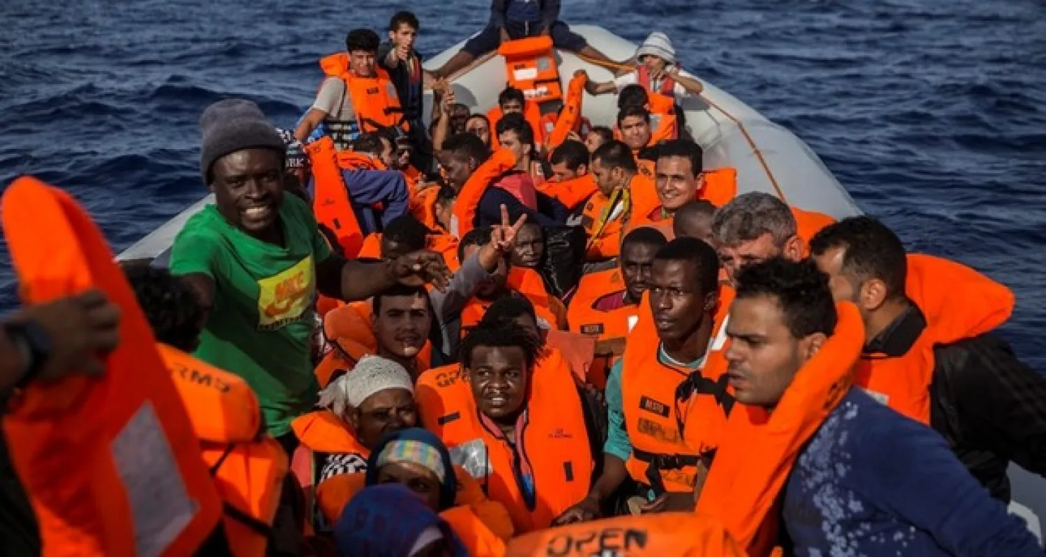 igrants aboard a rubber dinghy off the Libyan coast are provided of life vests by rescuers aboard the Open Arms aid boat, of Proactiva Open Arms Spanish NGO, Saturday, June 30, 2018. (AP Photo)
