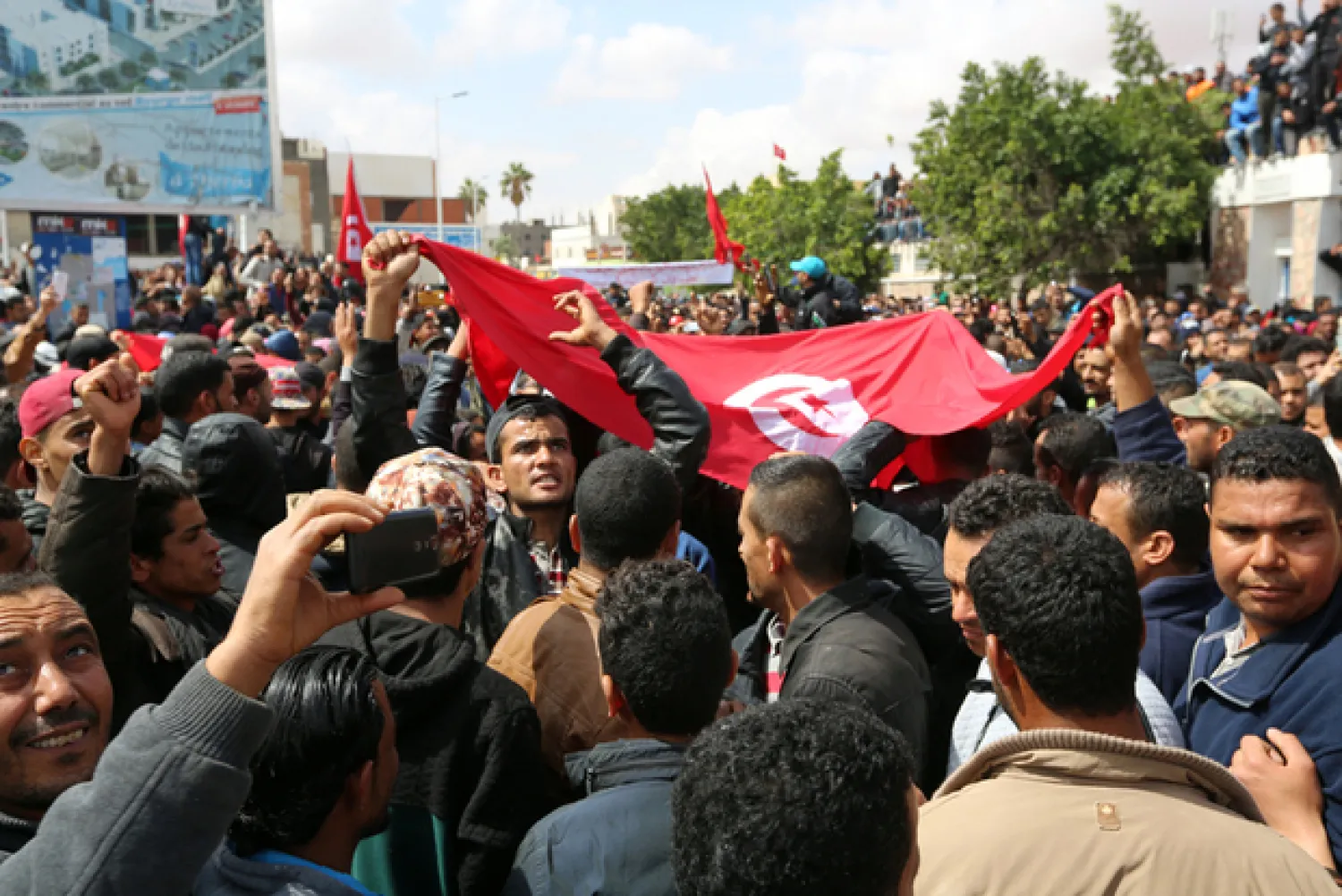 Tunisians wave national flags during general strike on April 11, 2017, in Tataouine (AFP)

