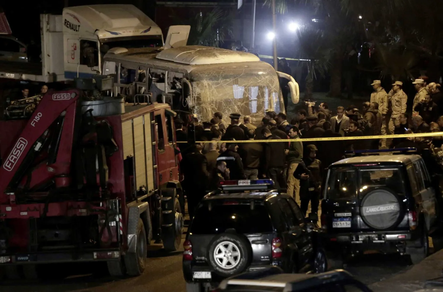 Security forces stand near the tourist bus that was attack on Friday. AP