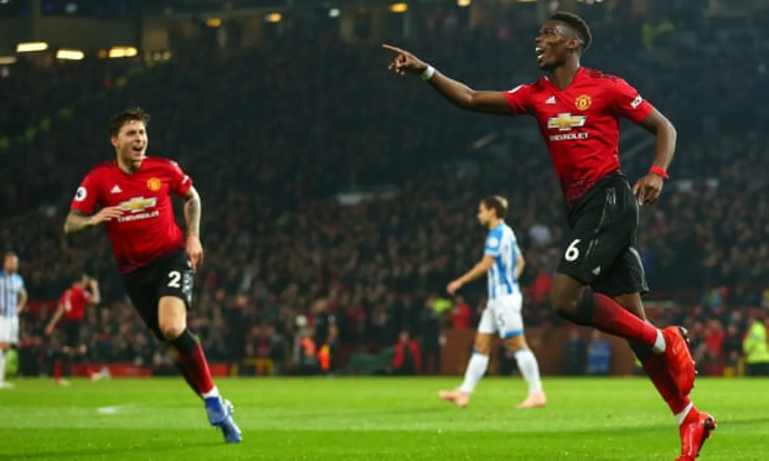 Paul Pogba celebrates making it 2-0 against Huddersfield Town and he then got a second. Photograph: Robbie Jay Barratt - AMA/Getty Images