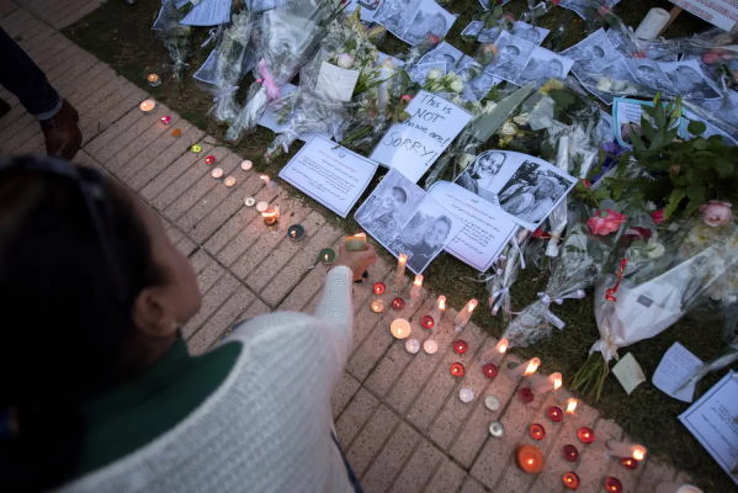  A person lights candles during a vigil for the two Scandinavian hikers, who were killed in Morocco's High Atlas mountains, outside the Norwegian Embassy in Rabat, Morocco, 22 December 2018.