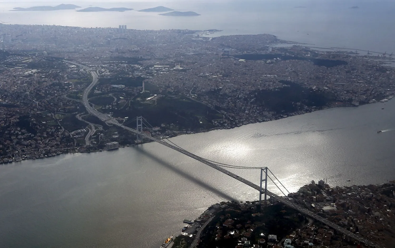 The Bosphorus bridge is pictured through the window of a passenger plane flying over Istanbul. (Reuters)