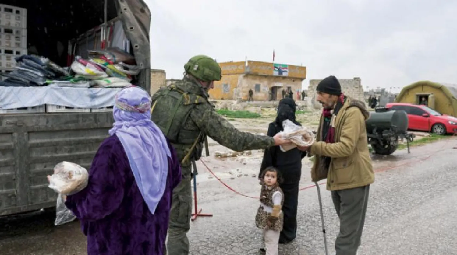 Geçtiğimiz Perşembe günü İdlib kırsalındaki Ebu Zuhur’da Suriyelilere yardım malzemeleri dağıtan Rus askeri (AFP)